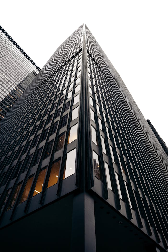 Striking low angle view of a modern skyscraper showcasing architectural design and vertical lines.
