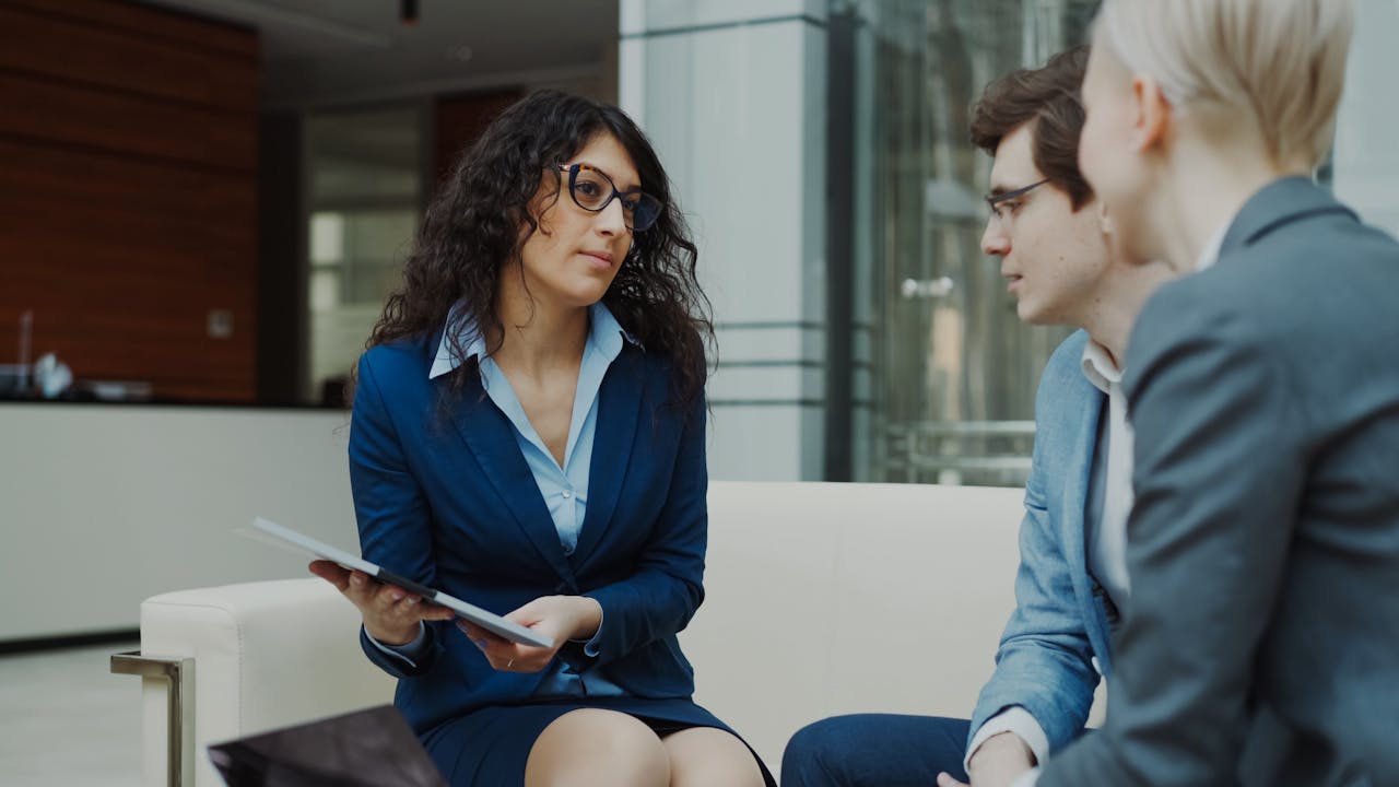 who-we-are A professional meeting with a team discussing business strategies in a modern office setting.